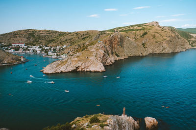 High angle view of rocks on sea shore against sky