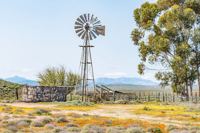 Windmill on field against sky