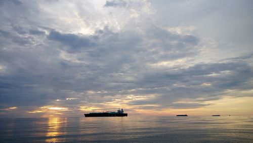 Scenic view of sea against cloudy sky