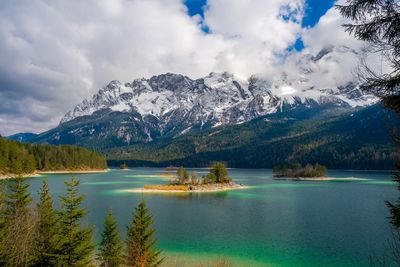 View of eibsee lake in the bavarian alps during winter. small islands in the middle of the lake.