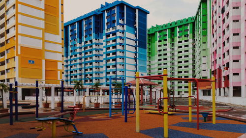 Empty chairs against buildings in city