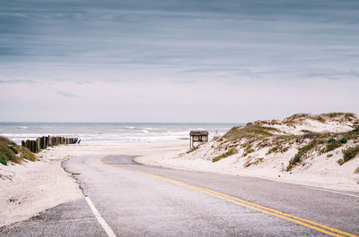 Empty road along calm sea