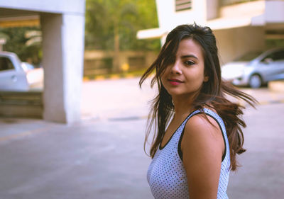 Portrait of smiling young woman standing outdoors