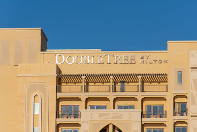 Low angle view of building against clear blue sky