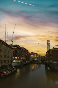 Bridge over river against sky during sunset