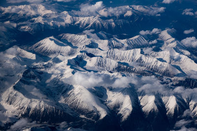 High angle view of snowcapped mountains against sky