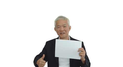 Portrait of man standing against white background