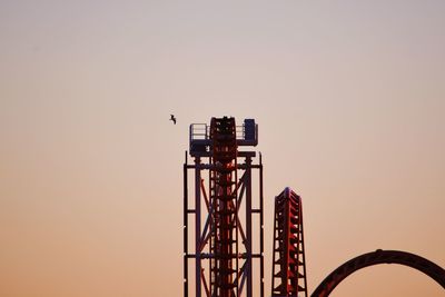 Low angle view of crane against clear sky