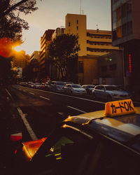 Cars on city street by buildings