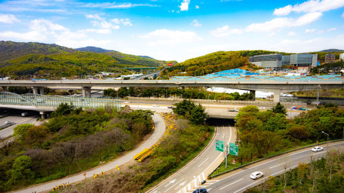 High angle view of road by bridge in city against sky