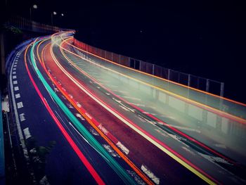 High angle view of light trails on highway at night