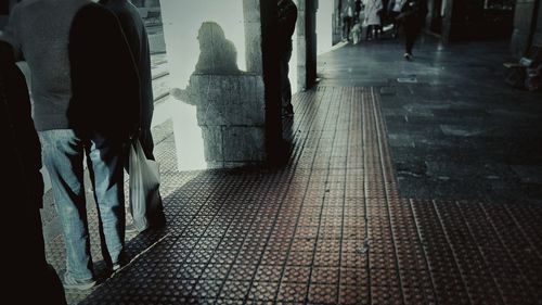 Low section of woman walking on wet floor