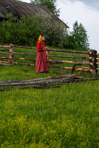 Rear view of woman standing on field