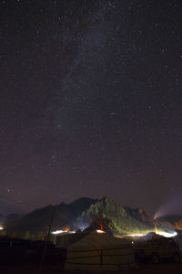 Scenic view of illuminated mountain against star field sky at night