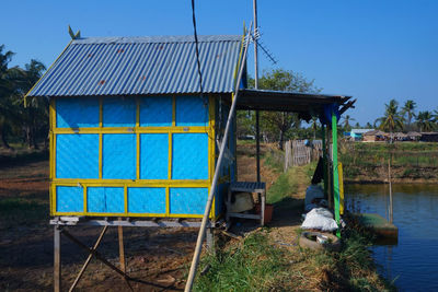 Low angle view of built structures against clear blue sky