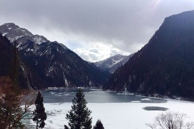 Scenic view of lake and mountains against sky