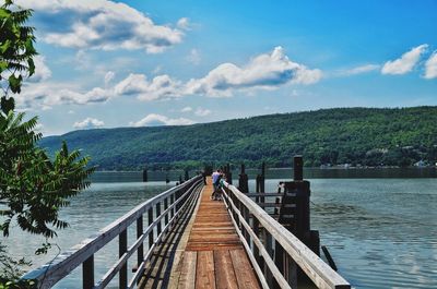 Pier over lake against sky