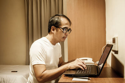 Portrait of man working on laptop