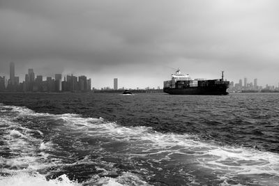 Ship sailing in sea against sky