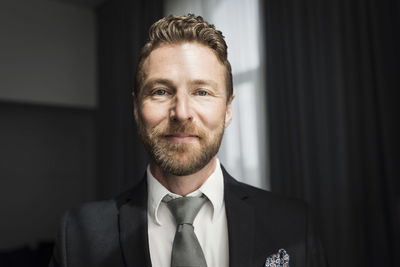 Portrait of happy businessman in hotel room