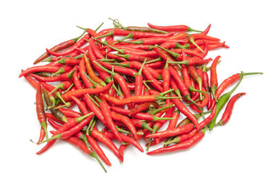 Close-up of red chili peppers against white background
