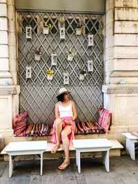 Full length of woman sitting on seat