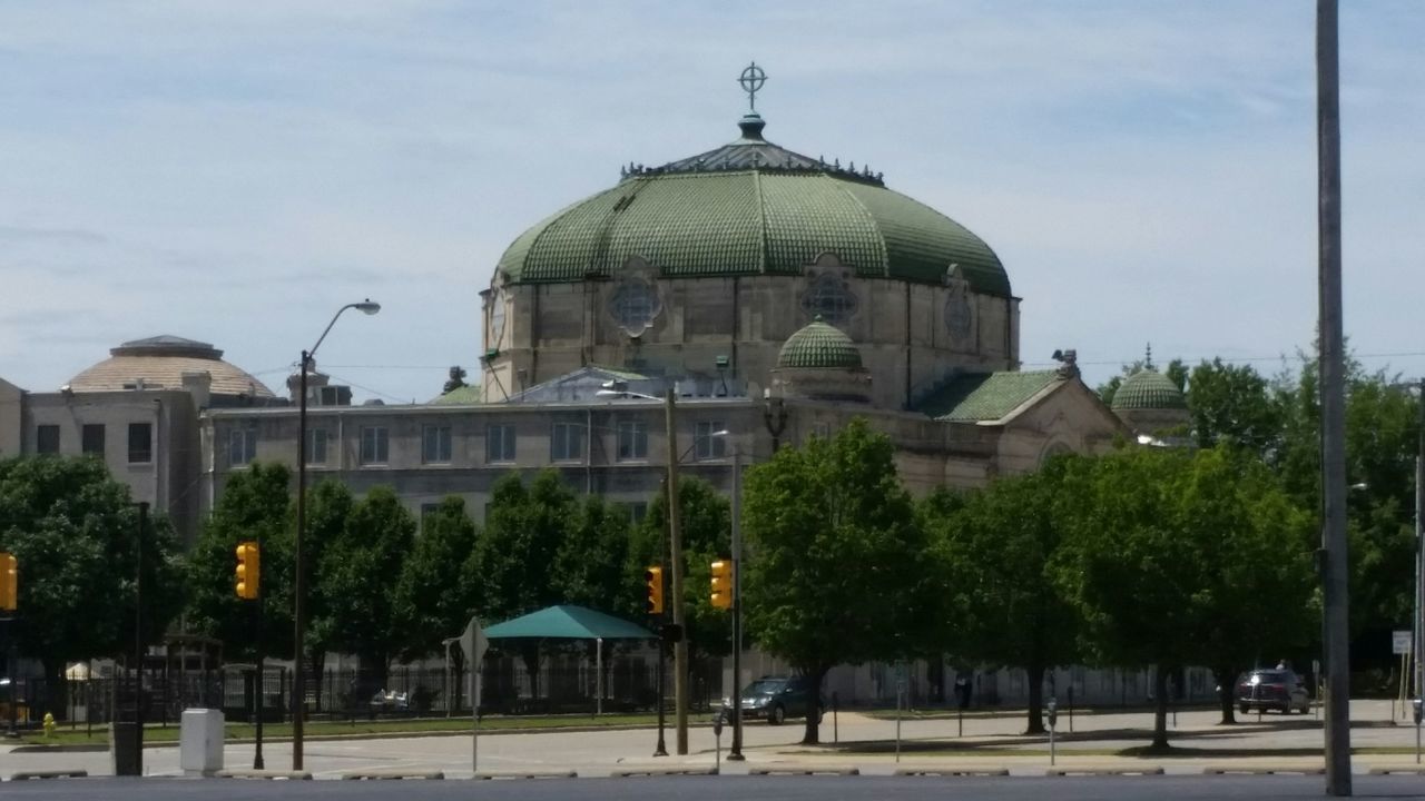 building exterior, architecture, built structure, place of worship, dome, religion, sky, spirituality, church, tree, facade, incidental people, cathedral, city, exterior, travel destinations, outdoors, cloud - sky