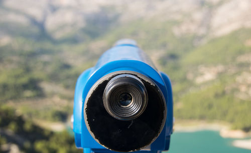 Close-up of coin-operated binoculars against blurred background