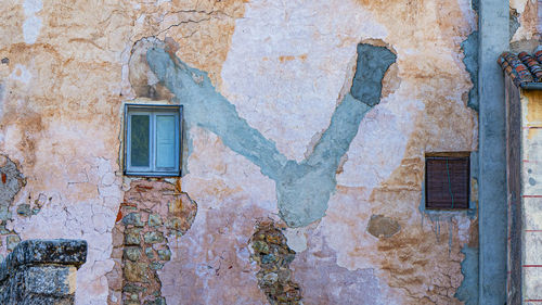 Low angle view of weathered wall of old building