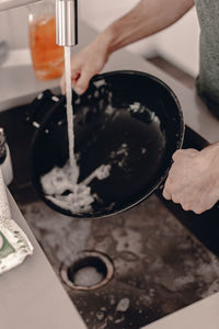 Midsection of person preparing food in kitchen