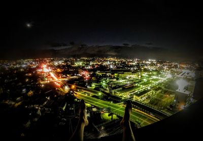 High angle view of illuminated cityscape against sky at night