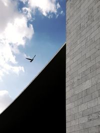 Low angle view of airplane flying against sky