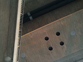 High angle view of piano keys on wooden floor