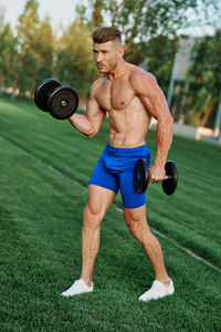 Low section of man exercising in gym