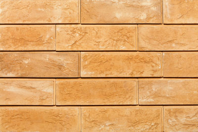 Wall and texture of brick tiles, beige background, close-up.