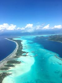 Aerial view of sea against blue sky