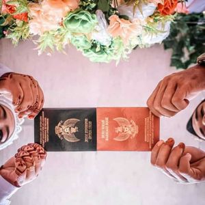 Close-up of hands holding flowers on table