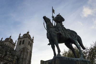 Low angle view of statue against sky