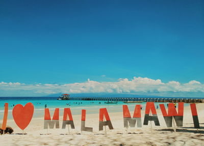Scenic view of beach against blue sky