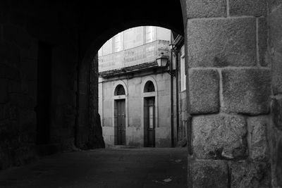 View of an old town street through the arch of a small tunnel