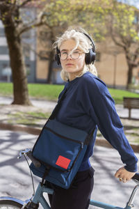 Young woman with headphones looking at camera