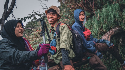 Young men in forest during winter