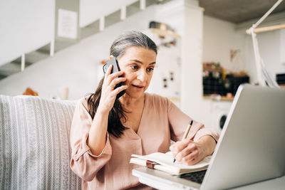 Midsection of woman using mobile phone