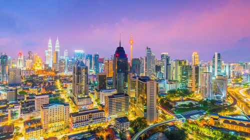 High angle view of illuminated buildings in city at night