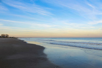 Scenic view of beach against sky during sunset