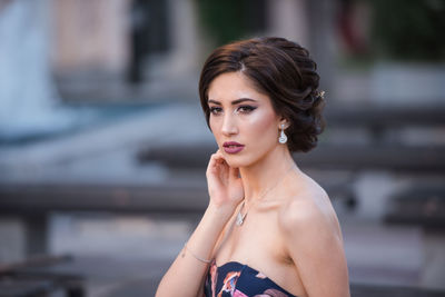 Portrait of beautiful woman against blurred background