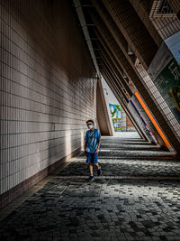 Rear view of boy walking on street