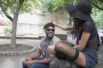 A young man and a young woman at a picnic table.