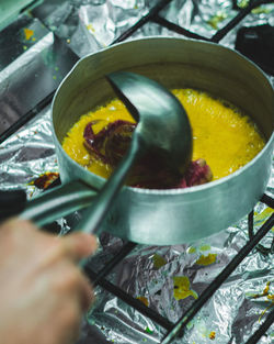 Cropped image of person preparing food in kitchen