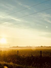 Scenic view of field against sky during sunset